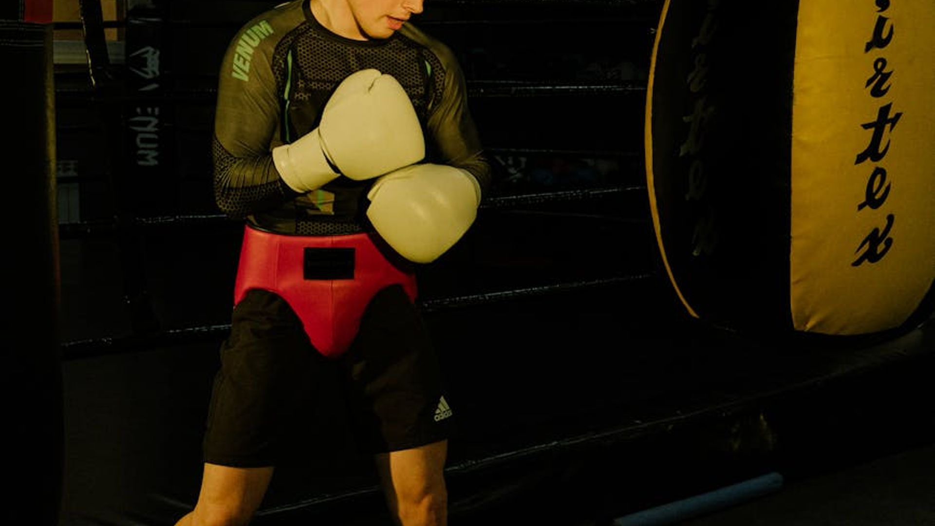 Silhouette of a man in a focused athletic stance.